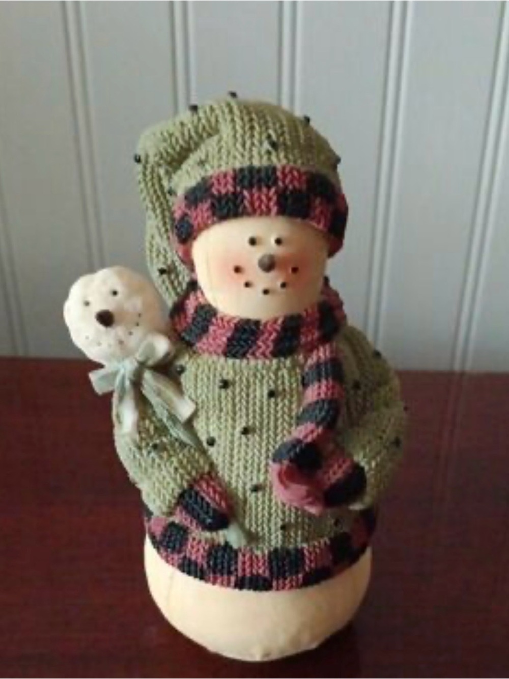The Plum Pudding Snowmen collection features a distinct, rustic style